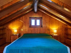 a bedroom with a blue bed in a wooden house at Holiday Home Il Crotto by Interhome in Pianello Del Lario +20 photos