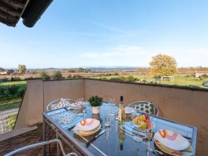 a table with plates of food on a balcony at Apartment Quercia Alta by Interhome in Le Case