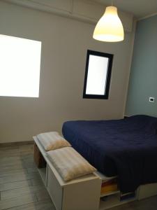 a bedroom with a blue bed and a window at Dimora Anna in Termoli