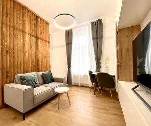 a living room with a couch and a table at Green House Studios in Braşov