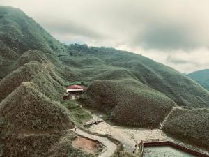 an aerial view of a mountain with a house on it at Daiwen Homestay in Jiaoxi