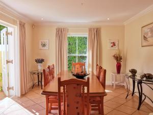 a dining room with a table and chairs and a window at River Club 4213 in Plettenberg Bay +11 photos