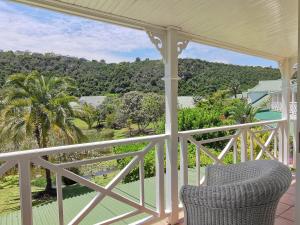 a porch with a chair and a view of the ocean at River Club 4213 in Plettenberg Bay