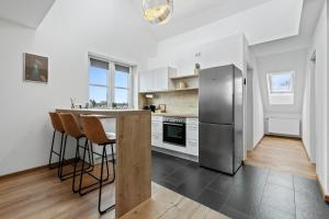 a kitchen with a stainless steel refrigerator and a counter at Casa Industrial: Design, Nespresso, Flughafennähe in Freising