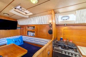 an rv with a stove and a kitchen in it at Voilier de 12m à Quai Port Canto in Cannes