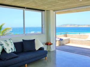 a living room with a couch and a view of the ocean at Betty in Plettenberg Bay