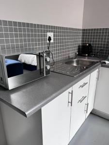 a kitchen with a toaster oven on a counter at Cosy Apartment next to Maboneng in Johannesburg