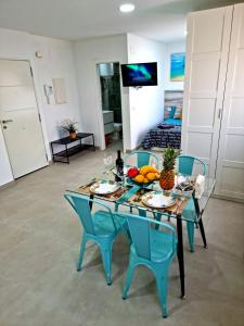 a table with fruit on it in a living room at APARTAMENTOS ELEMAR free luggage storage in Málaga