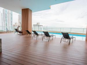 a group of chairs sitting on top of a building at Boutique Apartments Panamá Coco del Mar in Panama City +7 photos