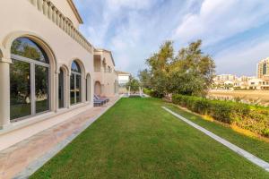 an exterior view of a house with a lawn at Maison Privee - Private Pool & Beach Access Villa with Cinematic Vws in Dubai