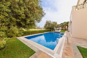 a swimming pool in the backyard of a house at Maison Privee - Private Pool & Beach Access Villa with Cinematic Vws in Dubai