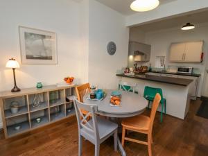 a kitchen and dining room with a table and chairs at Butler's Cottage in Scarborough