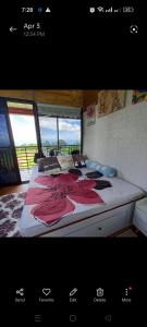 ダバオシティにあるshelos Happy Place by the Viewのベッドルーム1室(赤い花の大きなベッド1台付)