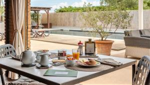 a table with food and drinks on it on a patio at Country Resort Le Due Ruote in Alberese