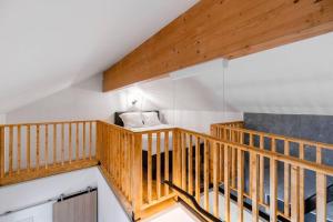 a wooden staircase with a couch in a room at Maison au bord de la Moselle in Argancy