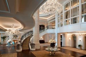 a large lobby with a chandelier and a staircase at The St. Regis Atlanta in Atlanta
