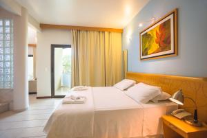 Postel nebo postele na pokoji v ubytování Wetiga Hotel