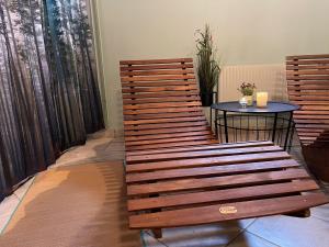 a wooden bench and a table in a room at Ferienhaus in Broakulla mit Sauna in Broakulla +22 photos
