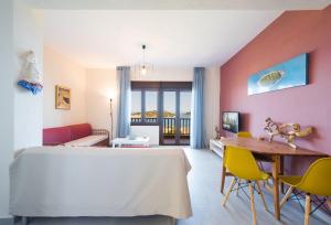 um quarto com uma cama, uma mesa e cadeiras em #FLH - Nereus & Oceanus Beachfront Apartments, Lagonisi Beach em Ormos Panagias