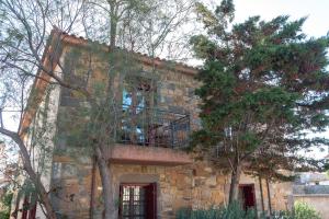 a stone building with a balcony on top of it at Lively Lofts by The Varos Residences in Város