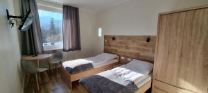 Posteľ alebo postele v izbe v ubytovaní Apartament, Pokoje Koniczynka