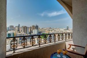 a balcony with a view of a city at Royal Tulip Apartments in Sharjah