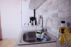 a kitchen sink with a lot of items on it at The Homey in Sidari +21 photos