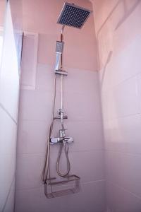 a shower with a shower head in a bathroom at The Homey in Sidari