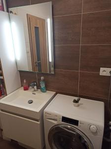 a bathroom with a washing machine and a sink at Severan New Appartement 2 in Martin +4 photos