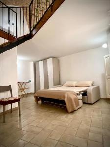 a bedroom with a bed and a staircase at Casa Tramonto in Alliste
