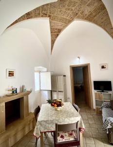 a kitchen with a table with a bowl of fruit on it at Casa Tramonto in Alliste