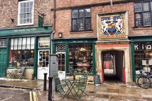 a store on a street with chairs outside of it at Bootes Cottage in York