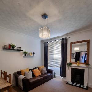 a living room with a couch and a mirror at Inverness City Centre Flat in Inverness
