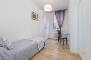 a bedroom with a bed and a table and a chair at Rialto Bridge Luxury apartment in Venice
