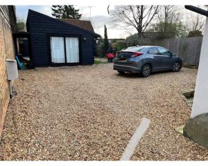 a car parked in a yard next to a house at Two Storey Annex in Cottenham