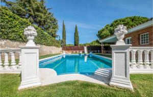 a pool in a yard with two columns at Stunning Home In St Andreu D,llavaneres With 4 Bedrooms, Wifi And Outdoor Swimming Pool in Sant Andreu de Llavaneres