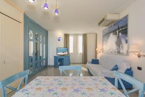 a living room with a table and a couch at L'incanto Di Boccadarno in Marina di Pisa