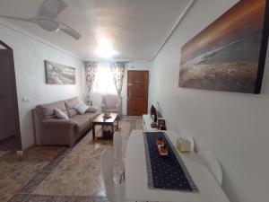 a living room with a couch and a table at Apartment in La Zenia in Orihuela Costa