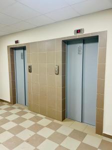 three elevators in a bathroom with tiled walls at Hostel 29 in Sofia