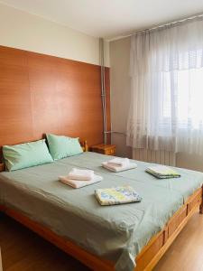 a bedroom with a large bed with two towels on it at Hostel 29 in Sofia