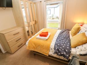 a small bedroom with a bed and a window at Rosie's Zen Den in Carlisle