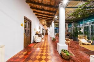 a lobby with a checkered floor and a column at Posada El Pucara in San Javier