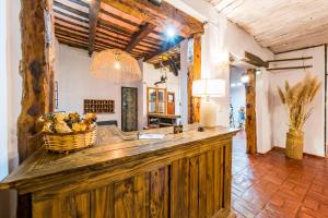 a kitchen with a large wooden counter in a room at Posada El Pucara in San Javier