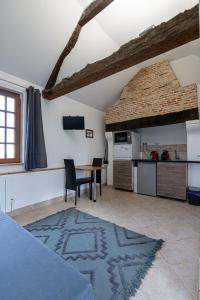 een keuken en eetkamer met een tafel in een kamer bij La Bouillerie du Manoir des Bréholles in Goustranville