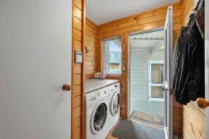 a laundry room with a washer and dryer at Piece of Paradise - Turangi Holiday Home in Turangi