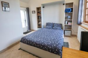 GoustranvilleにあるLa Bouillerie du Manoir des Bréhollesのベッドルーム1室(青い枕のベッド1台付)