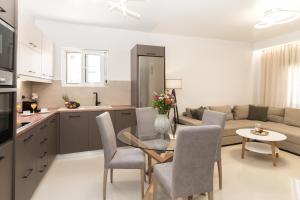 a kitchen and living room with a table and a couch at Al Santo Apartments in Zakynthos