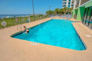 a woman is playing in a swimming pool at Sunset Coral in Myrtle Beach