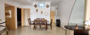 a dining room with a table and chairs at DSAF Family Homestay Pandan Indah in Ampang