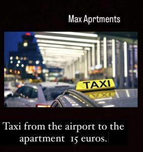 a taxi sign on top of a parking lot with cars at Max Apartments in Podgorica